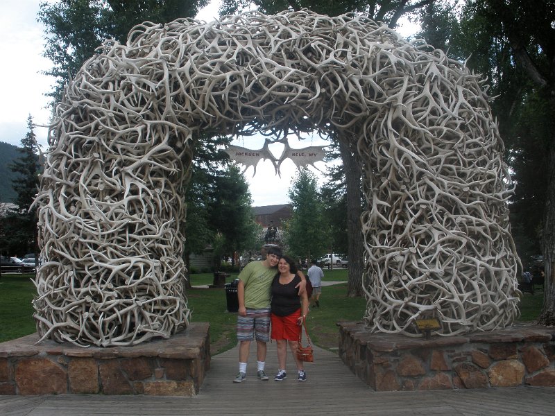 Trip (46).JPG - Kris and Sharon in front of one of the Antler Arches.  Jackson Hole is home to the National Elk Refuge, located just about a mile from Jackson’s Town Square. For nearly 50 years local Boy Scouts have assisted the refuge by gathering the winter sheds. Some of these antlers are used to build the town arches.